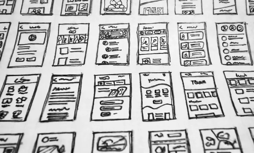 A series of design prototype sketches on a large piece of paper.